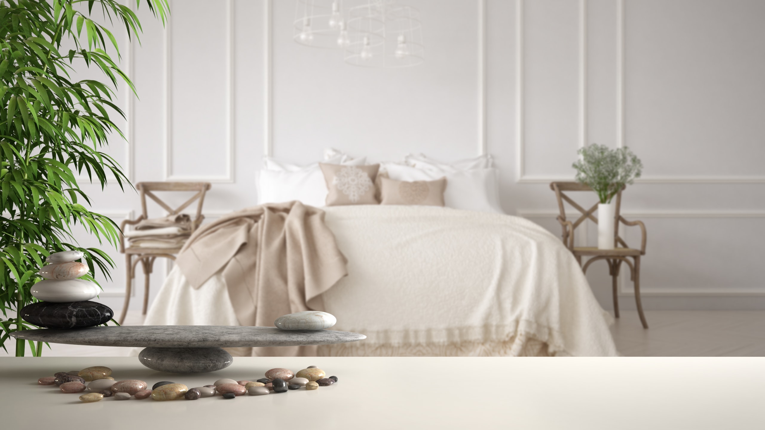 feng shui concept white table shelf with pebble balance and bamboo plant over vintage classic bedroom with soft bed full of pillows and blankets